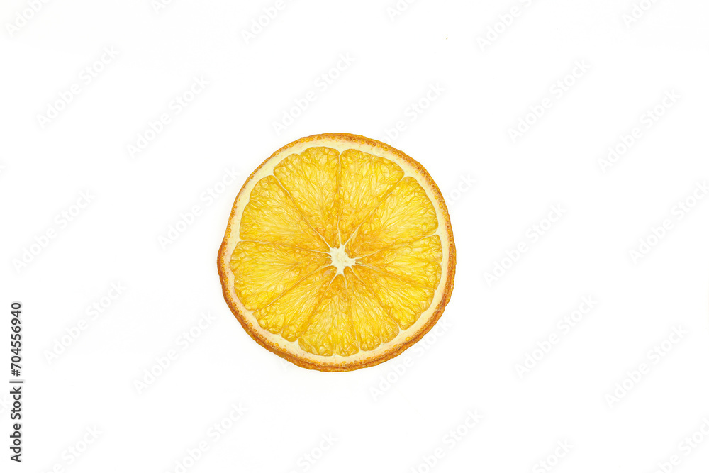 Sliced piece of dry dehydrated orange isolated on white background.