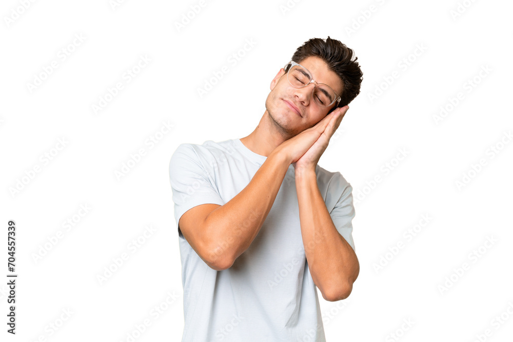 Young caucasian handsome man over isolated background making sleep gesture in dorable expression Young caucasian handsome man over isolated background making sleep gesture in dorable expression