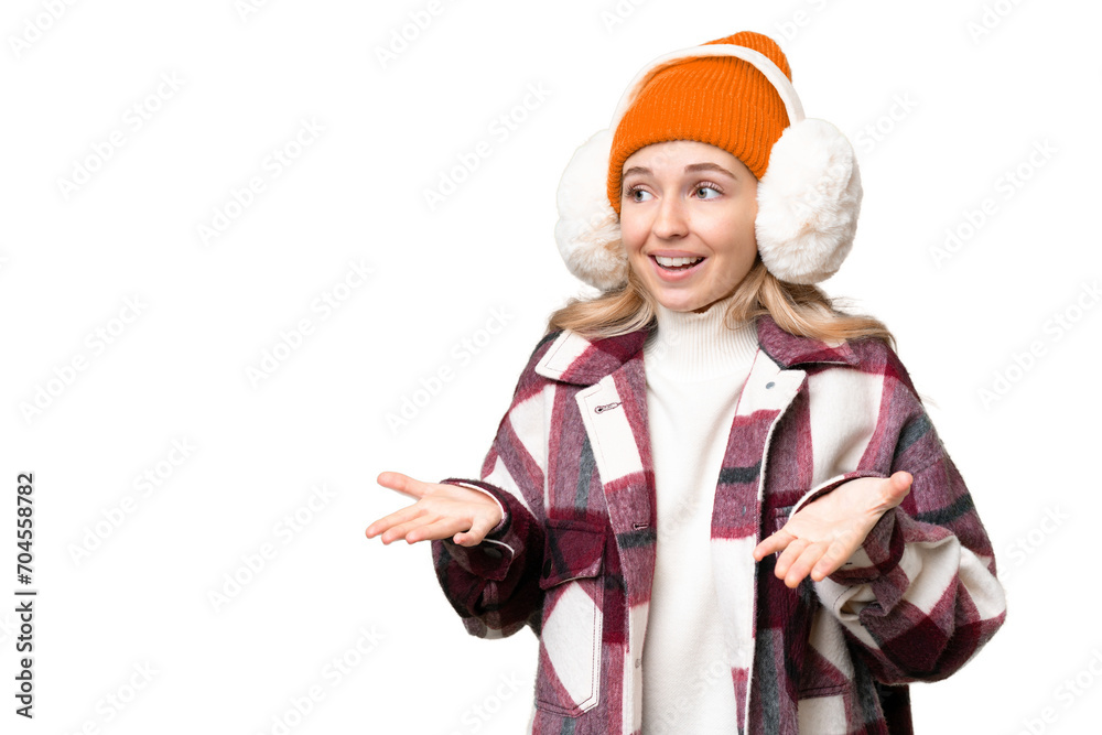 Young  English woman wearing winter muffs over isolated background with surprise facial expression