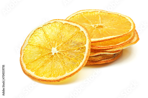 Stacked dehydrated slices of dried orange isolated on white background