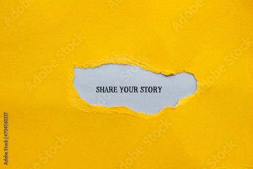 Share your story lettering on ripped yellow paper with gray background. Conceptual photo. Top view, copy space for text.