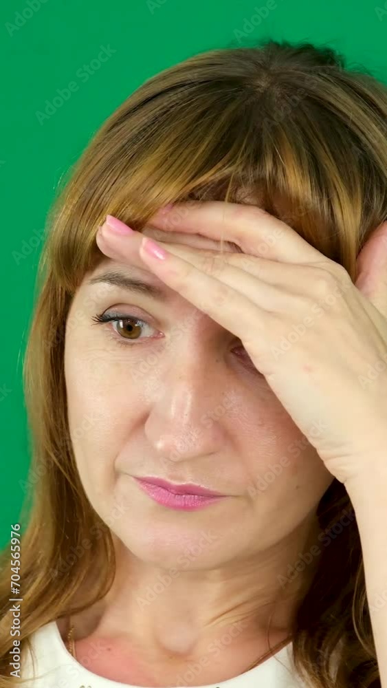 Experiences negative unpleasant emotions wave head negatively no put palm to forehead hurts head problem illness solutions middle-aged woman on green background Chromakey suffering sadness Bad news Experiences negative unpleasant emotions wave head negatively no put palm to forehead hurts head problem illness solutions middle-aged woman on green background Chromakey suffering sadness Bad news