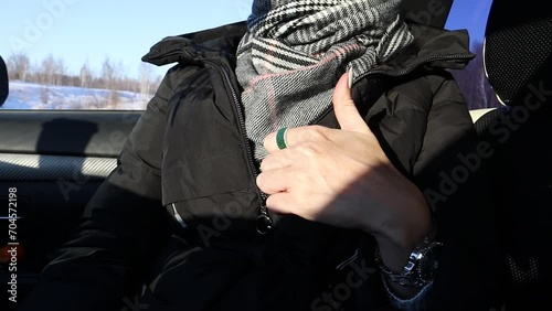 A hand gesture is to show a liking with your hand. The girl raises her finger up to show approval