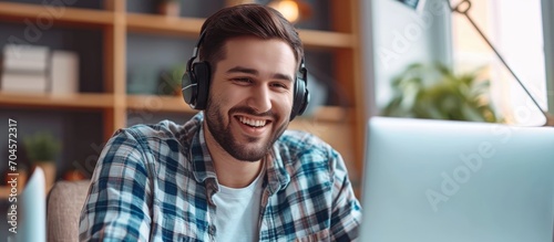 Communication and contact can be made through a call center using laptop video calls with a happy man talking. This can be used for telemarketing sales pitch, e-commerce call center, or online webinar