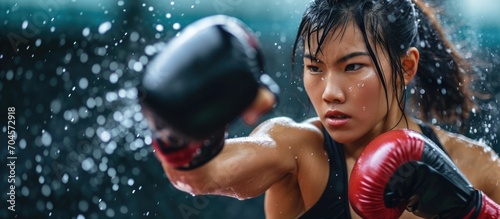 Asian woman boxing, strong, high kick, kickboxing movement. photo