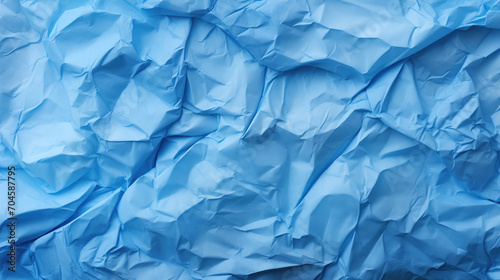 Blue creased crumpled paper background grunge texture backdrop.