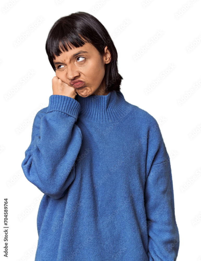 Young Hispanic woman with short black hair in studio who feels sad and pensive, looking at copy space. Young Hispanic woman with short black hair in studio who feels sad and pensive, looking at copy space.