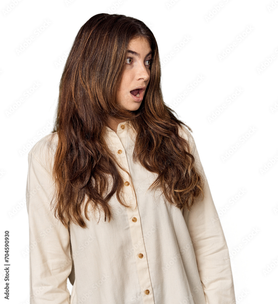 Young Caucasian woman in studio setting being shocked because of something she has seen. Young Caucasian woman in studio setting being shocked because of something she has seen.