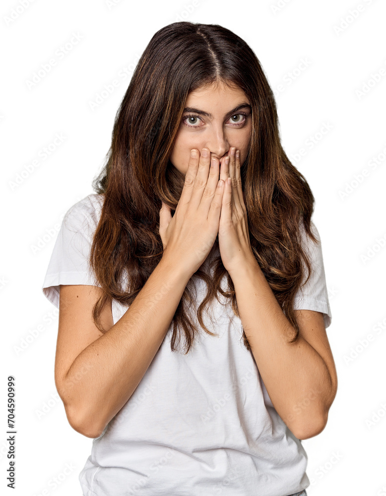 Young Caucasian woman in studio setting shocked, covering mouth with hands, anxious to discover something new. Young Caucasian woman in studio setting shocked, covering mouth with hands, anxious to discover something new.