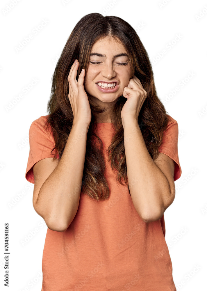 Young Caucasian woman in studio setting covering ears with hands. Young Caucasian woman in studio setting covering ears with hands.