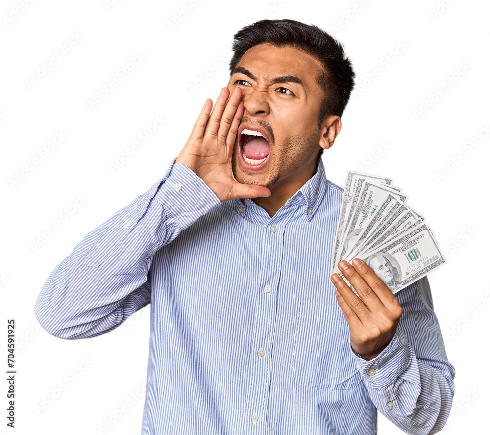 Young Chinese man holding dollar bills in studio shouting and holding palm near opened mouth. Young Chinese man holding dollar bills in studio shouting and holding palm near opened mouth.