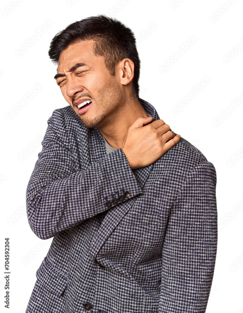 Young Chinese man in studio background having a shoulder pain. Young Chinese man in studio background having a shoulder pain.