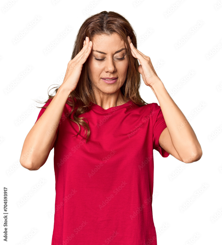 Middle-aged woman portrait in studio setting touching temples and having headache. Middle-aged woman portrait in studio setting touching temples and having headache.