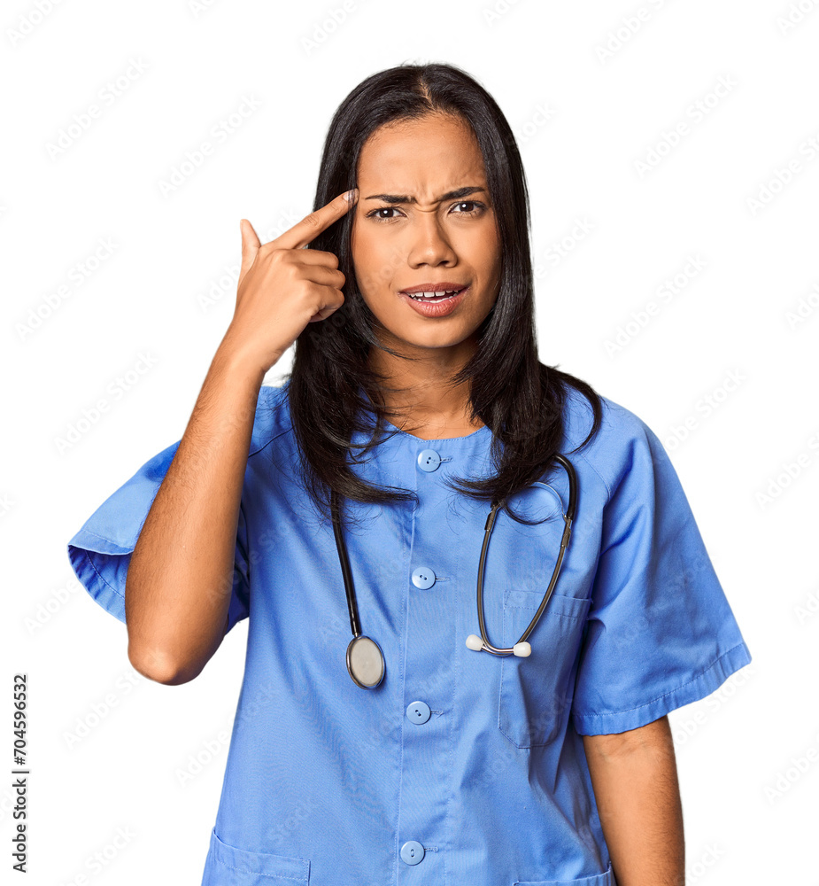 Young Filipina nurse posed in studio showing a disappointment gesture with forefinger. Young Filipina nurse posed in studio showing a disappointment gesture with forefinger.