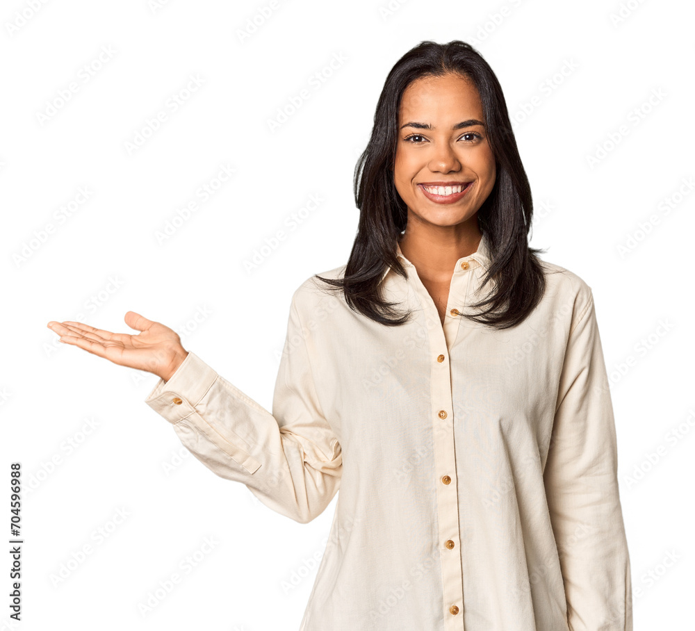 Young Filipina with long black hair in studio showing a copy space on a palm and holding another hand on waist. Young Filipina with long black hair in studio showing a copy space on a palm and holding another hand on waist.