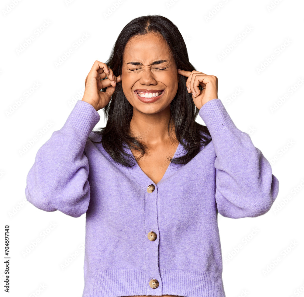 Young Filipina with long black hair in studio covering ears with hands. Young Filipina with long black hair in studio covering ears with hands.
