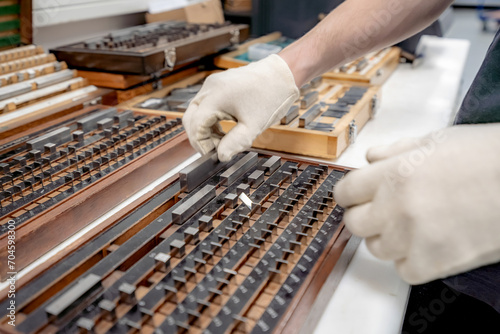 The worker selects gauge blocks to obtain the required control size of the part being manufactured and adjusts the measuring tool of a CNC metal-cutting machine.