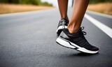 Athlete runner feet running on road closeup on shoe. sunrise workout wellness concept.