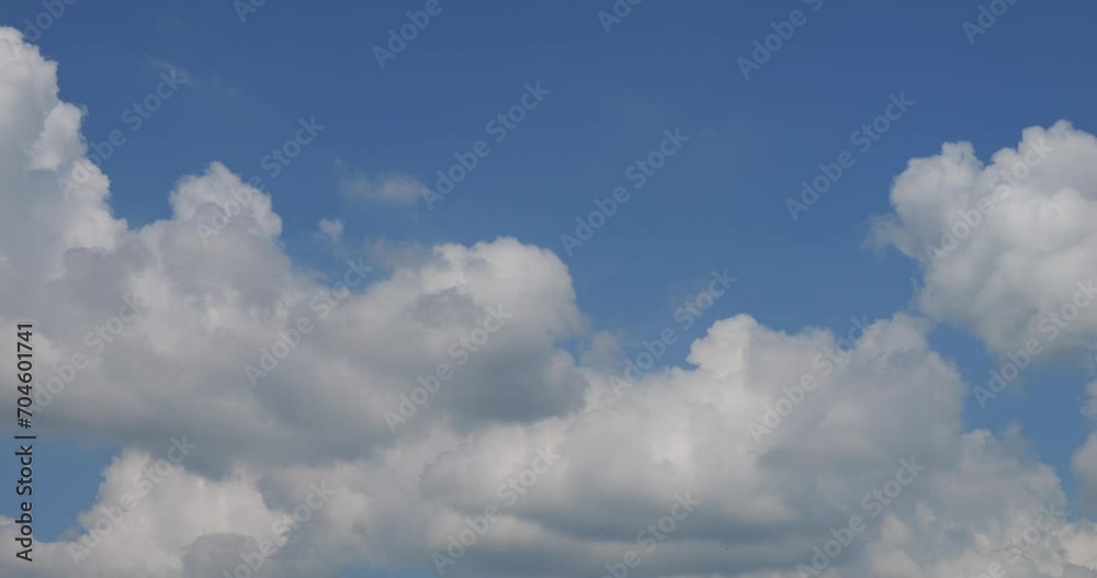 Beautiful white clouds curl and fly against the background of the blue sky. Beautiful white clouds curl and fly against the background of the blue sky.