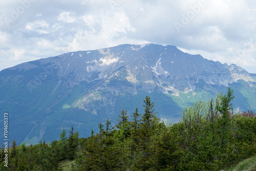 Beautiful panoramic view to famous Ötscher mountain in Lower Austria on a cloudy day. Wonderful and idyllic Ötscherland landscape with hills and lakes