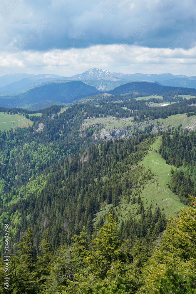Small green hills and steep snowy mountains in Ötscherland, Lower Austria