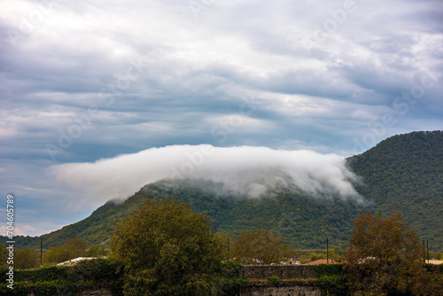 Cloud lies on the mountain. View of the mountains from the territory of the Kindzmaraulli wine factory in the city of Kvareli, Kakheti region, Georgia.