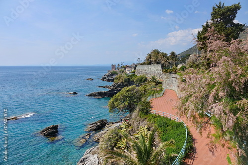 Panoramic view of the Tigullio gulf from the sea promenade on the rocky coast of Genoa Nervi with the medieval Gropallo tower built in the 16th-century as a watchtower for pirates photo