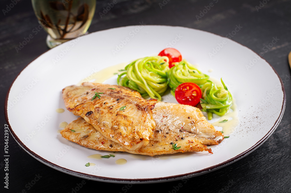 Grilled fish fillet with zucchini pasta. Healthy food concept. Grilled fish fillet with zucchini pasta. Healthy food concept.
