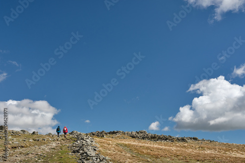 Photography Two hikers ascend Hart Crag on the Fairfield Horseshoe, Lake District, UK