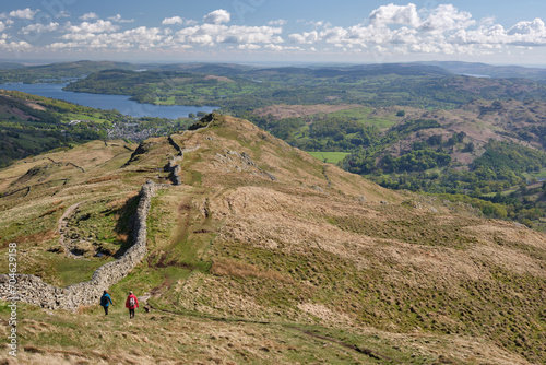 Windermere and Ambleside seen with hikers on descent to Low Pike from High Pike, on Fairfield Horseshoe, Lake District, UK photo