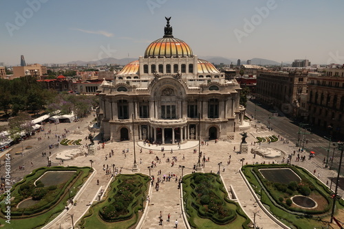 The beautiful Palacio de Bellas Artes/Palace of Fine Arts and the square and flower beds in front of it on a busy day, Mexico City