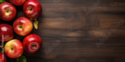 Top view of ripe garden apple fruits on a wooden table, with copy space.