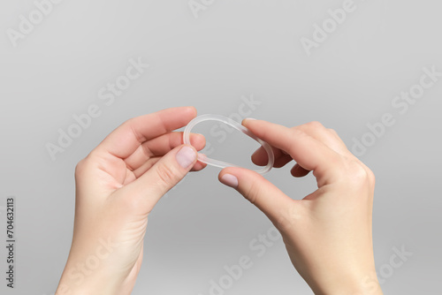 female hands holding hormonal contraceptive ring photo