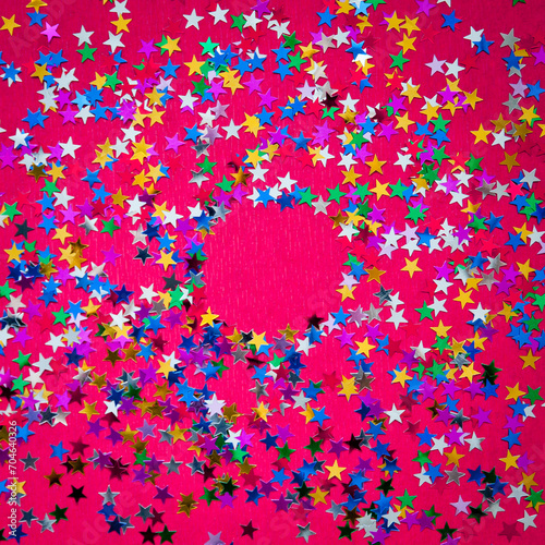 Round glitter frame on red background with copy space. Layout. Multi-colored stars.