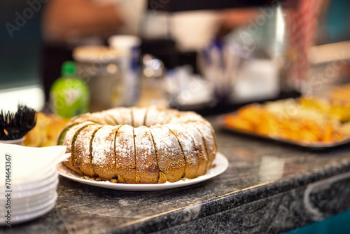 Homemade traditional sweet sponge cake with vanilla dough sprinkled with powdered sugar, Chocolate cake on the wedding table, food at the celebration