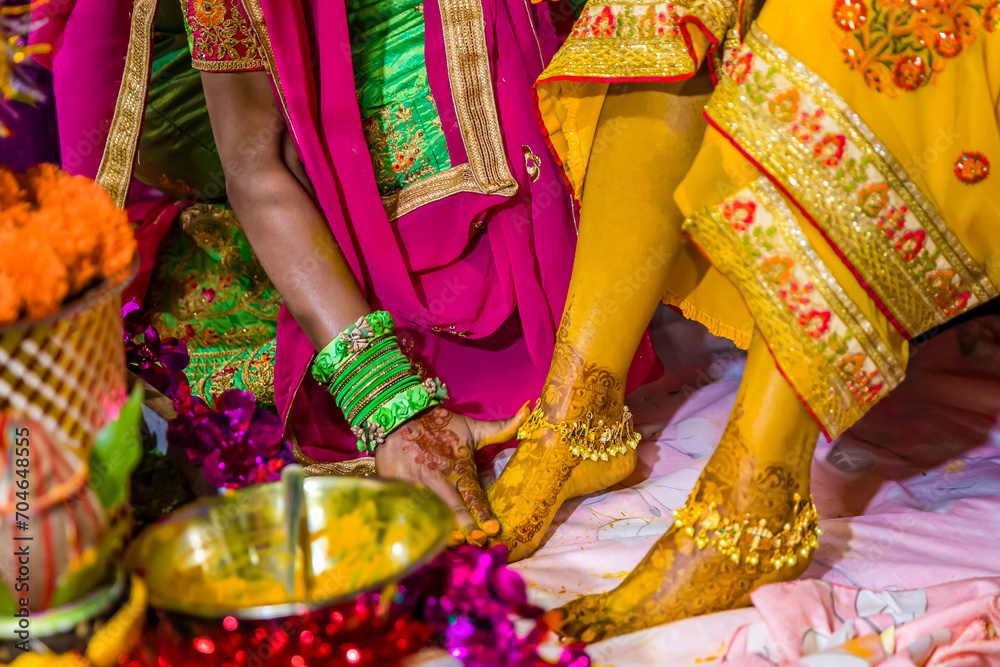 Indian Hindu pre wedding yellow turmeric Haldi ceremony feet close up