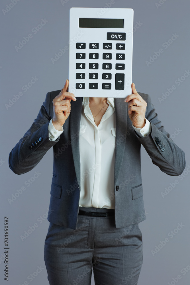elegant 40 years old woman worker isolated on grey background elegant 40 years old woman worker isolated on grey background