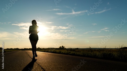 silhouette sports girl running along road sunset, training hard, energetic female runner training competition, recreation running, celebrating victory. woman race winner, athletics fitness, woman