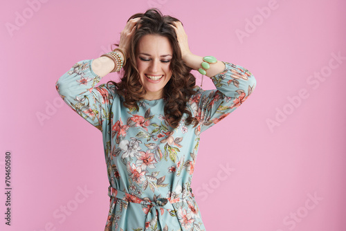 cheerful elegant 40 years old woman in floral dress on pink photo