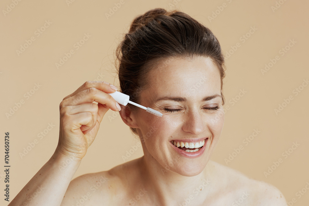 Fototapeta premium woman with brow brush isolated on beige