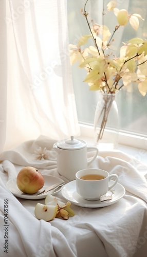 Still life with a cup of tea and a pear