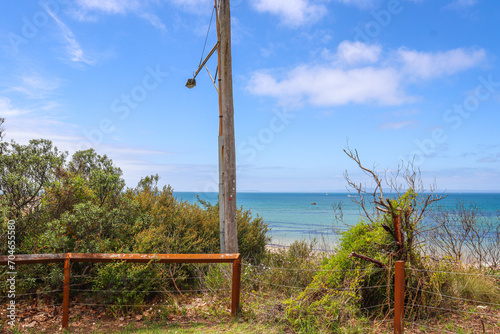 seaside foreshore landscape with old fence and light pole