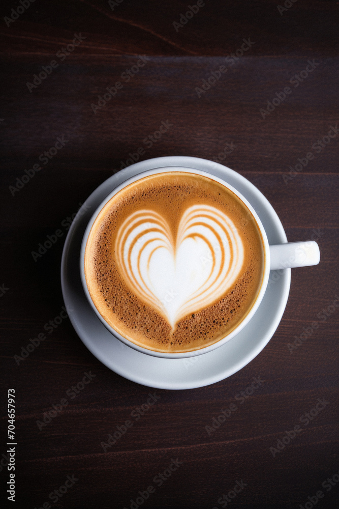 Coffee cup with heart shape latte art on wooden background. Coffee cup with heart shape latte art on wooden background.