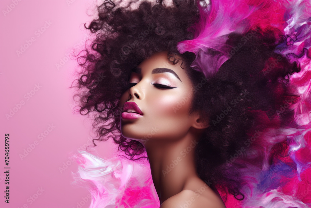 Stunning woman with voluminous curly hair and a colorful smoke effect on a pink background