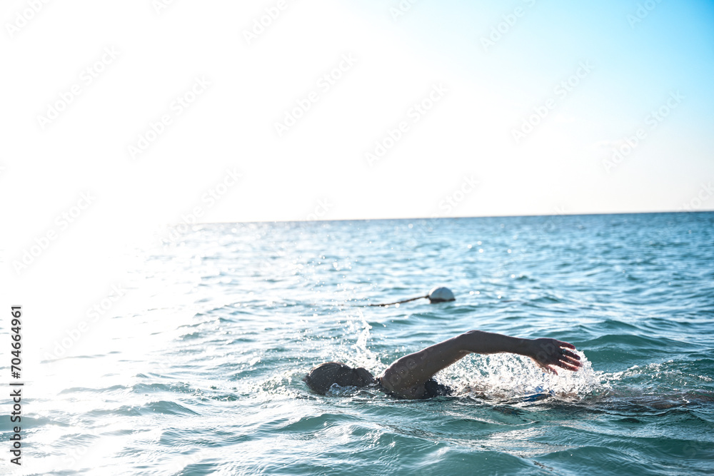 Woman swimming and exercising on the beach in Jamaica