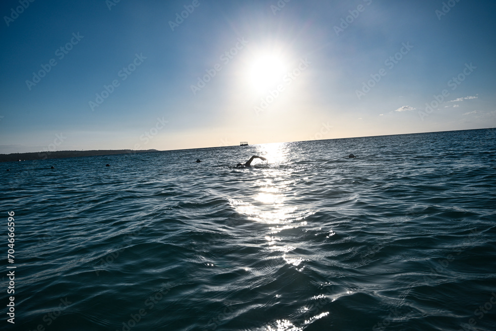 Fototapeta premium Woman swimming and exercising on the beach in Jamaica