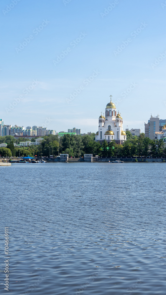 Church on Blood in Honour of All Saints Resplendent in Russian Land. Russian Orthodox church in Yekaterinburg. On shore of city pond formed by dam on Iset River. Vertical image Church on Blood in Honour of All Saints Resplendent in Russian Land. Russian Orthodox church in Yekaterinburg. On shore of city pond formed by dam on Iset River. Vertical image
