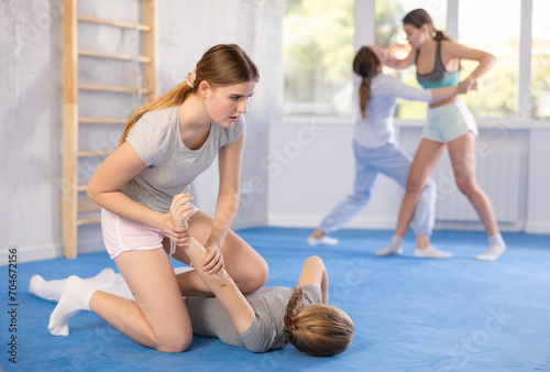 Pair self-defense training - two teenage girls doing power grabs