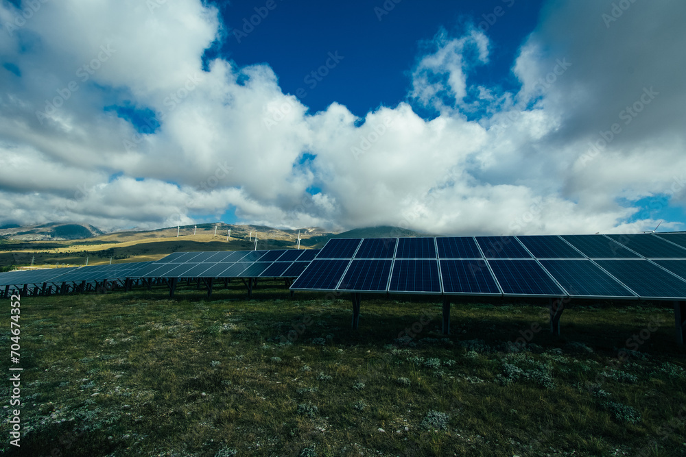 Photovoltaic system and a wind farm. Solar and Wind power are the use of solar and wind for electrical power. Popular sustainable, renewable energy for enviromental energy batteries generated megawatt Photovoltaic system and a wind farm. Solar and Wind power are the use of solar and wind for electrical power. Popular sustainable, renewable energy for enviromental energy batteries generated megawatt
