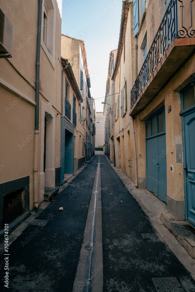 Narrow street on an old street in Narbonne, France